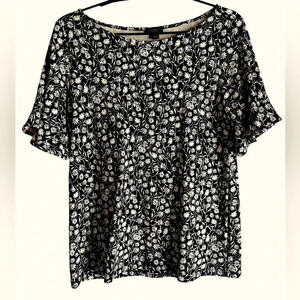 Ann Taylor outlet top. Black with dainty white flowers, ruffled sleeves. Sz S